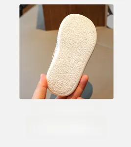 Detail of white toddler shoe sole featuring non-slip texture and size 23 embossing