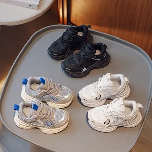 Breathable mesh children's sneakers in black, white, and silver grey on a display