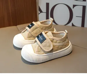 Macro shot of durable rubber sole with non-slip texture on cream baby toddler sneakers