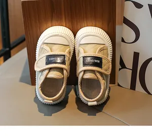 Detailed close-up of quilted toddler walking shoes with velcro strap and rubber toe cap