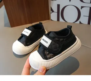 Detail of toddler sneakers with black quilted material and anti-slip rubber toe cap