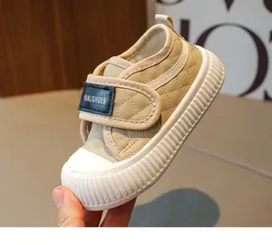Detailed view of beige quilted toddler shoes featuring anti-slip rubber soles and velcro