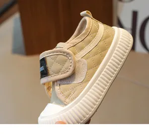 Detail of khaki quilted leather toddler sneaker with velcro strap and rubber toe cap