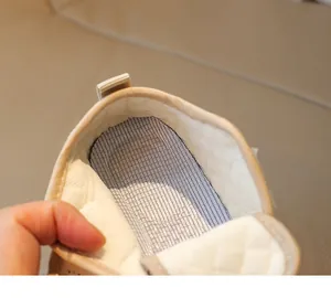 Close-up of baby walking shoe interior featuring breathable mesh insole and quilted lining