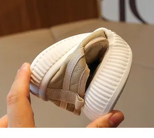 Close-up of flexible khaki baby walker shoe with quilted stitching showing its soft sole