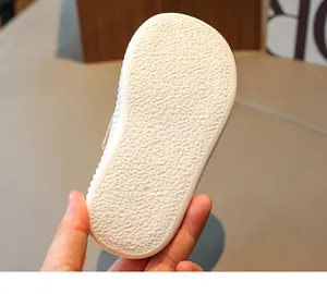 Detail of toddler shoe sole with anti-slip texture and size number 23 marking