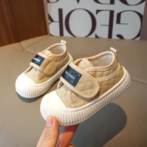 Quilted beige toddler sneakers with non-slip rubber soles and velcro straps