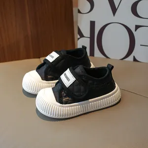Quilted black and white toddler walking sneakers with non-slip sole and velcro strap