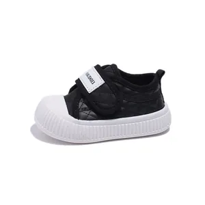 Toddler casual sneakers in black with diamond quilting and protective white rubber toe cap