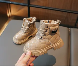 Detail of beige quilted patent leather kids boots with side zipper and warm lining