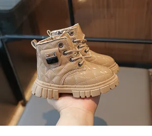 Close-up of quilted patent leather toddler boots with rhinestone buckle and thick sole