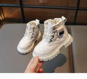 Close-up of white patent leather kids boots with quilted texture and side zipper