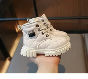 Close-up of quilted cream leather kids boots with side pocket detail and thick soles