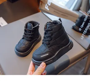 Detail of kids winter boots featuring quilted black design and side zipper for easy wear