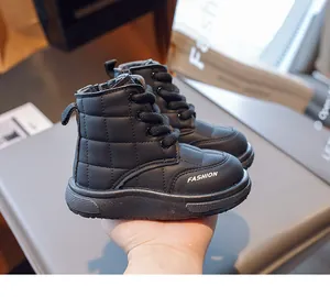 Detail of black quilted leather kids snow boots with side zipper and thick non-slip soles