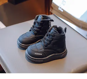 Close-up of black quilted winter boots for children with plush lining and side zipper