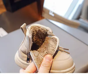 Close-up of warm brown plush lining and side zipper on children's quilted winter boots