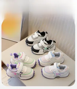 Close-up of kids sneakers showing mesh material, star patterns and velcro closures