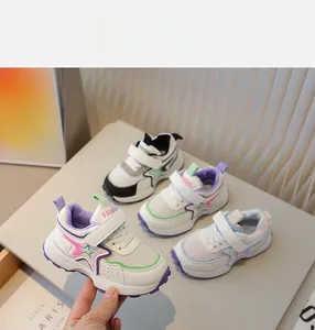 Detail of breathable mesh kids sneakers with gradient star motif and velcro straps