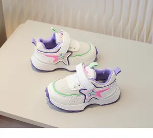 Detail view of breathable mesh kids sneakers with colorful star and velcro strap
