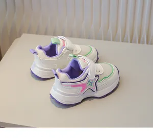 Detail of children's breathable mesh sneakers with hook and loop closure and star logo
