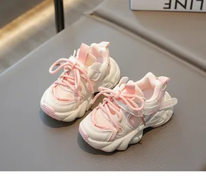 Detailed close-up of pink breathable mesh fabric and wavy non-slip sole on toddler sneakers