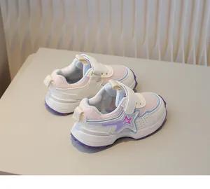 Detail of pink mesh children sneakers with star pattern and double velcro straps