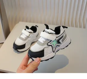 Detail of kids breathable mesh sneaker with velcro strap and green star patch decoration