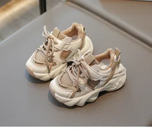 Macro view of kids' chunky mesh sneakers showing non-slip sole and hook-and-loop strap