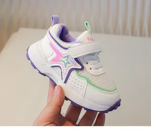 Detail view of children's mesh sneakers with star motifs and velcro strap closure