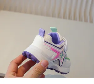 Detailed view of child sneakers with mesh fabric, gradient star motif and velcro strap