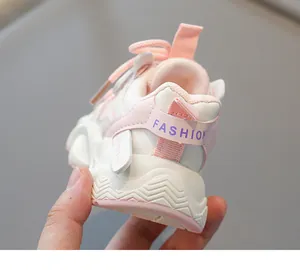 Close-up of pink and white kids' sneakers showing breathable mesh and non-slip thick sole