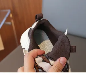 Détail de la doublure en mesh doux et du col marron sur les chaussures de course enfant