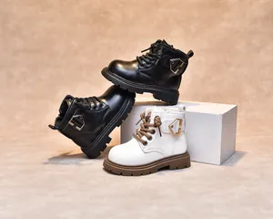 Detail view of premium leather kids boots with metal buckle and anti-slip thick rubber sole