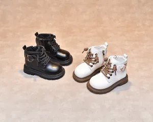 Detail of kids leather boots showing side zipper closure and metallic buckle decoration