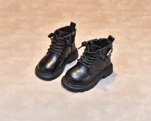 Detail view of children's black matte leather martin boots with anti-slip rubber soles