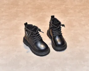 Detail of black leather kids boots featuring side zipper, laces, and thick rubber sole