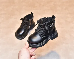 Detail of soft black leather kids' boots showing side zipper and non-slip rubber sole