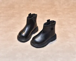 Detail view of children's black matte leather boots with anti-slip rubber thick soles