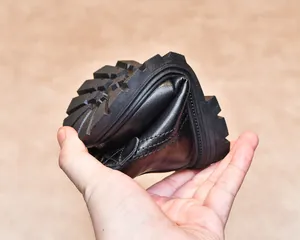 Close-up of flexible black leather boot showing its highly bendable soft rubber sole