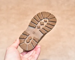 Detail of tan rubber sole for children boots showing non-slip tread and size mark