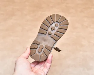 Detailed close-up of non-slip rubber sole for children boots with deep grip texture