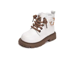 Detail view of white children's Martin boots with brown laces and thick anti-slip rubber soles