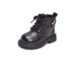 Detail of kids black combat boots showing side zipper, metal buckle, and thick rubber sole