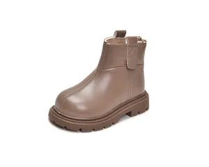 Macro detail of kids matte leather ankle boot with side zipper and rugged rubber sole