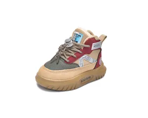 Detail of warm kids snow boots with khaki suede patchwork and faux wool lining