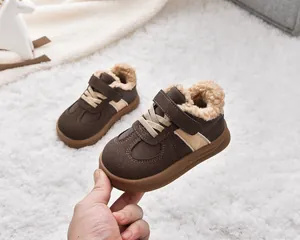 Detail of warm brown winter boots for kids with cozy faux shearling lining and velcro strap