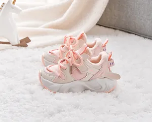 Detail of pink and beige kids winter sneakers with warm fleece lining and side velcro strap