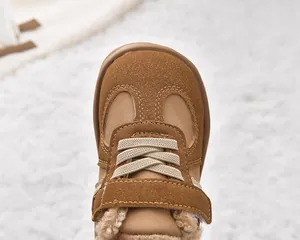 Close-up of brown suede toddler winter boots with warm fleece lining and velcro closure