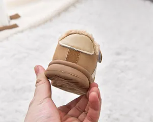 Detailed back view of children's fleece-lined brown boots with non-slip rubber soles